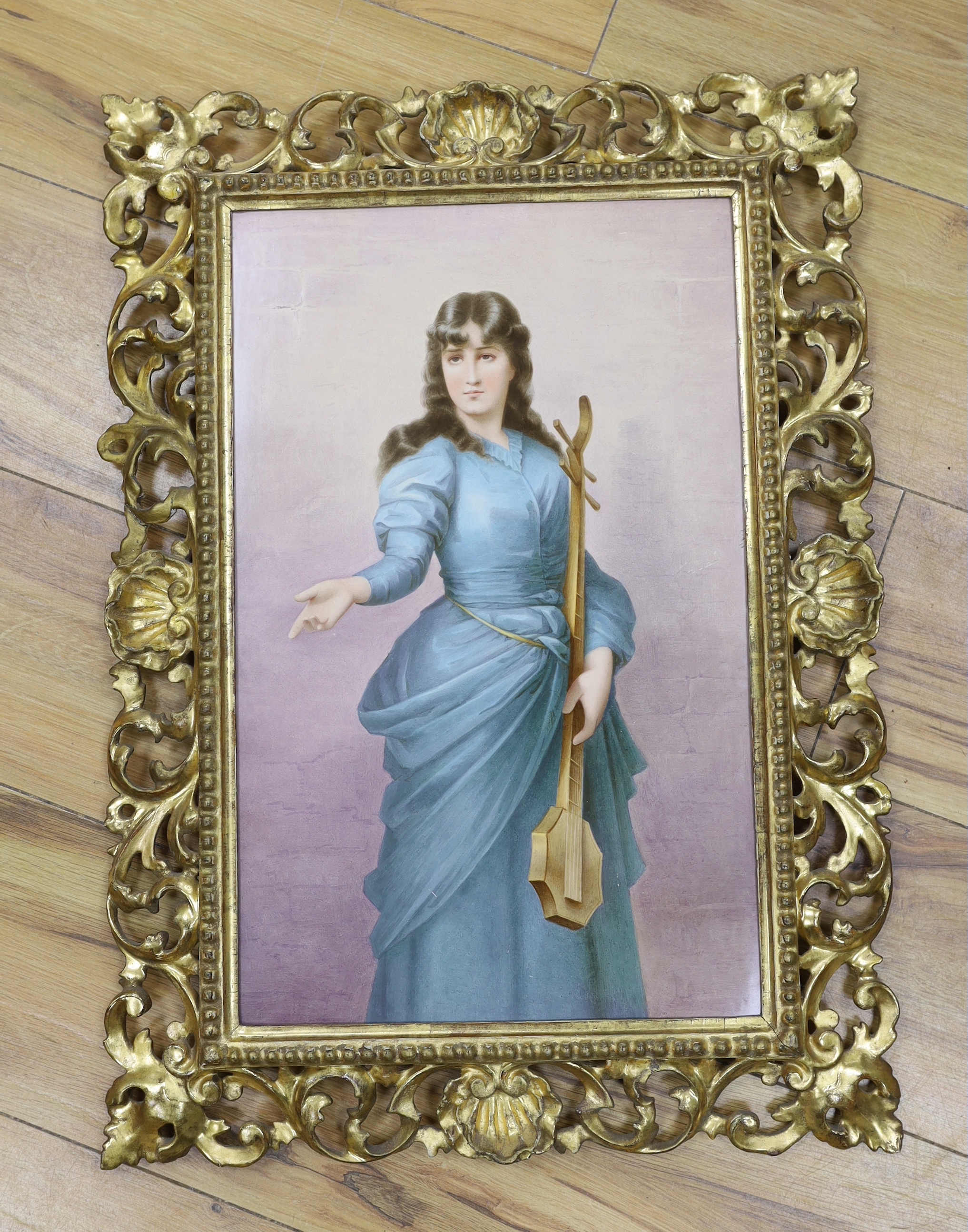 A large Vienna style porcelain plaque of a lady musician, indistinctly signed, gilt Florentine frame, 43x27cm